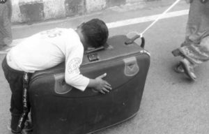 Migrant labour on a suitcase