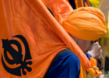Sikh boy holding Nishan Sahib